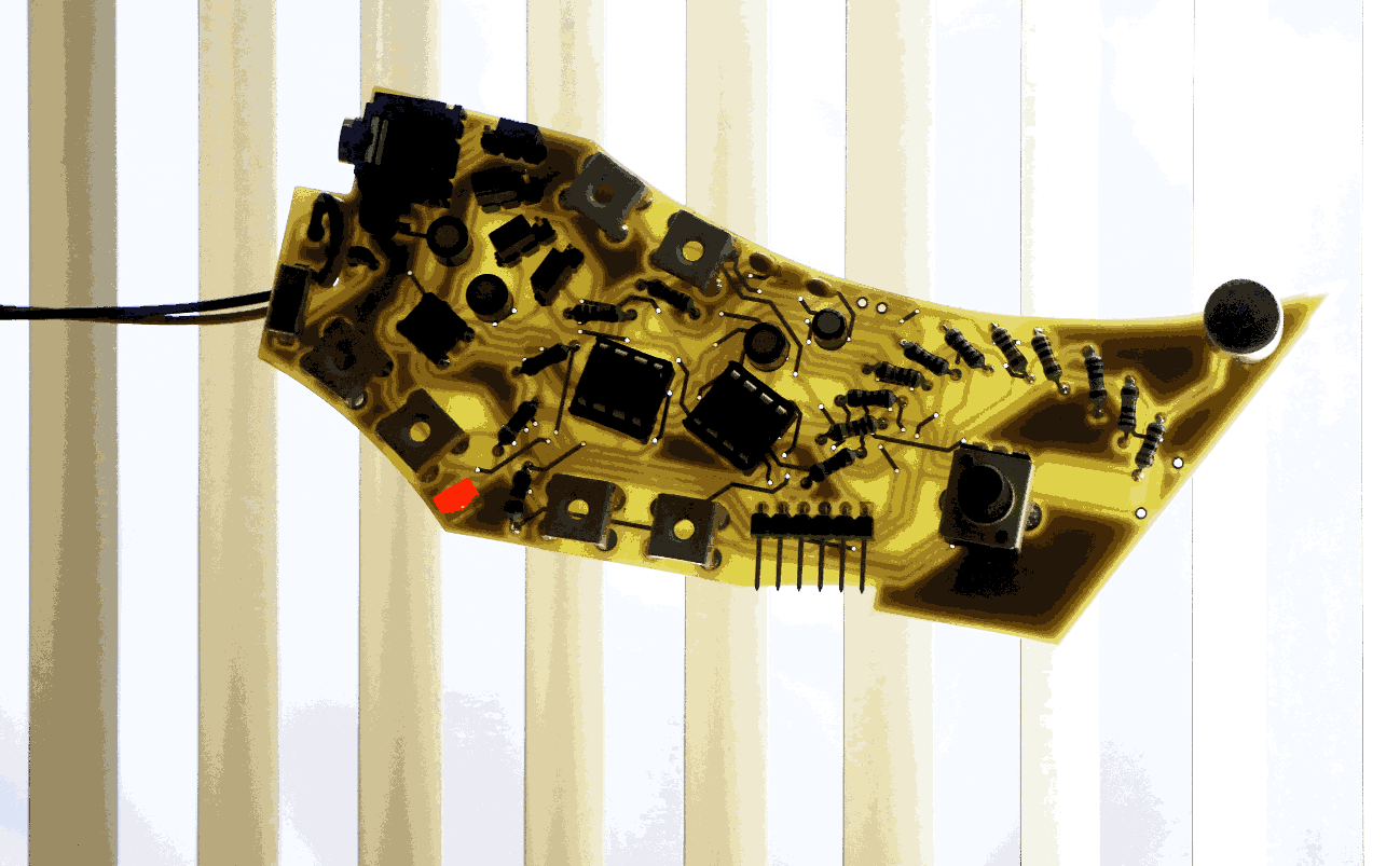 an angular pointed yellow pcb with a striped background